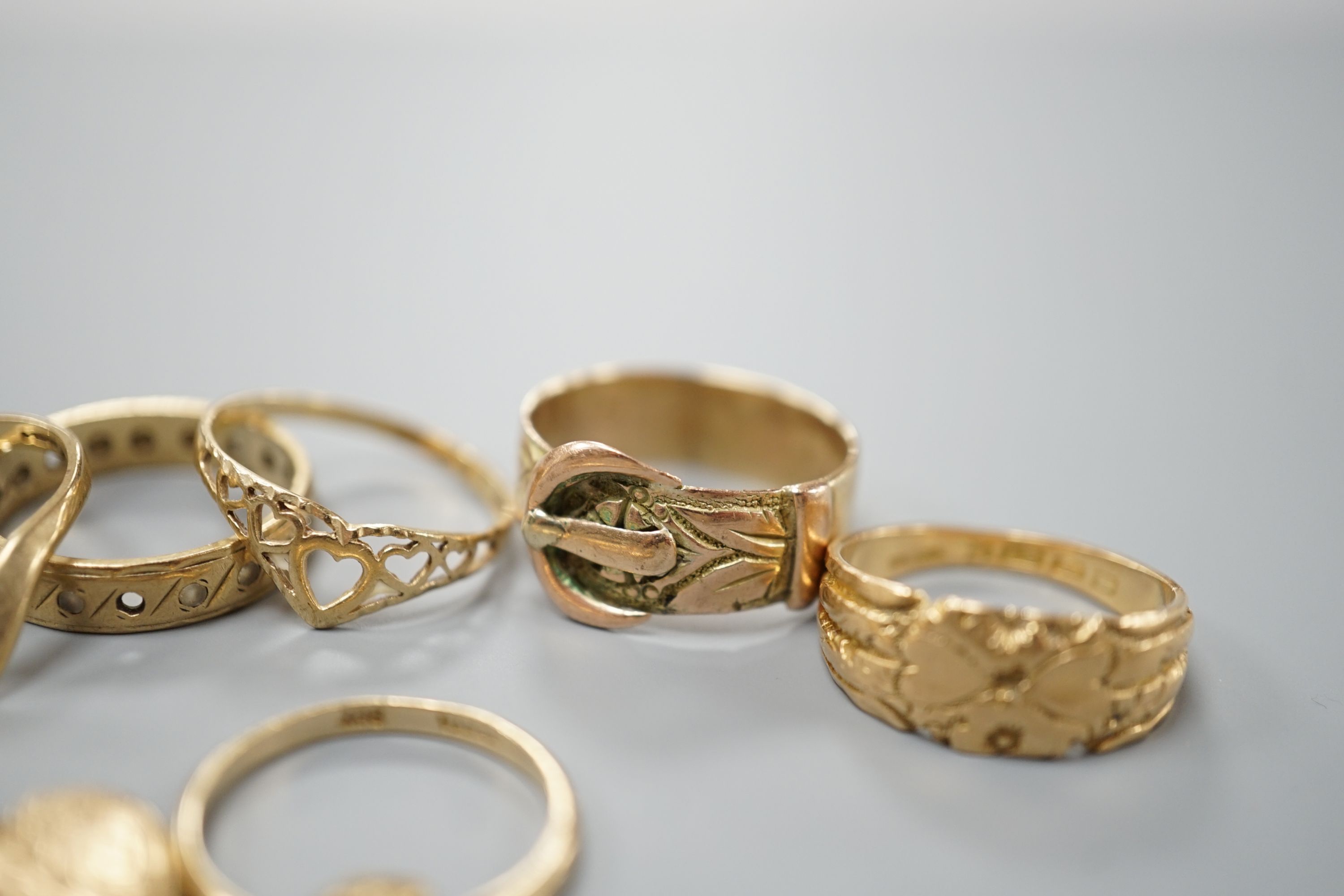 Four assorted 9ct gold rings, a 9ct gold heart pendant and a 9ct and paste set ring, gross 8.3 grams, an Edwardian 18ct gold ring, 4.4 grams and a yellow metal ring, 4 grams.